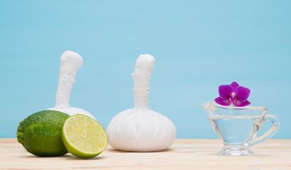 blue background with a set of bags and massage oil orchid