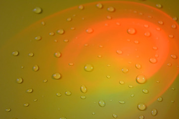 Abstract background: orange semicircles on a yellow background with drops