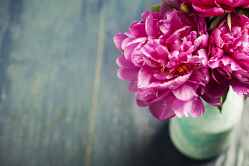 Beautiful magenta peonies in turquoise blue vase