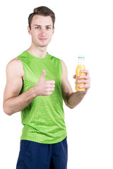 Fototapeta premium Healthy lifestyle. Portrait of a handsome guy with juice and a thumb up, in sportswear, isolated on a white background, looking at the camera. Vertical frame