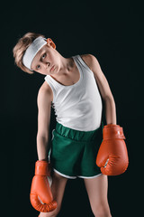 tired boy in boxing gloves isolated on black, active kids concept