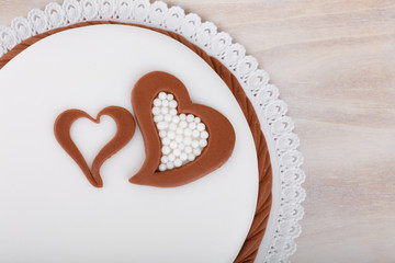 valentine love cake with hearts on wooden background