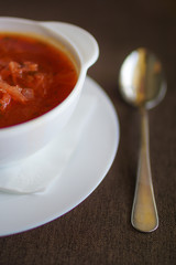 soup in a white plate with baked tortilla