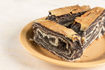 Poppy seed roll cake with copy space over wooden background