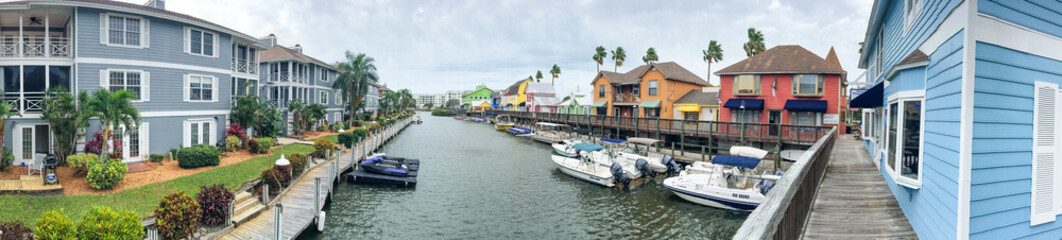 SIESTA BEACH, FL - FEBRUARY 2016: Panoramic view of colourful homes along canal. Siesta Beach is a famous destination in Florida - obrazy, fototapety, plakaty