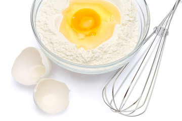 Flour with egg in glass bowl