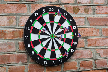 dart in bullseye on the target with many other Darts