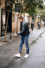 Confident and handsome young man in the street