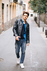 Confident and handsome young man in the street