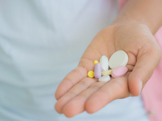 medicine, health care and people concept - close up of woman taking in pill