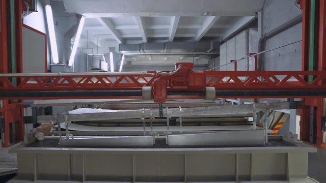 Manufacture. Process of anodizing aluminum products  in production, Immersion of aluminum plates in liquid. Automatic production line.  4k footage. 
