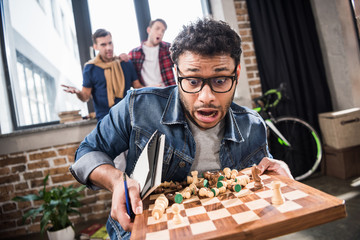 man holding chess board