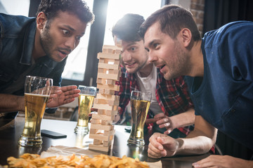 men playing jenga game