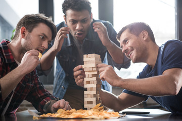 young people playing jenga game