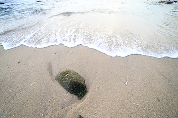 Rock and wave on the Ao Sen beach Phuket Thailand