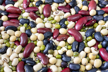 mix of beans on wood table. green bean, soybean, black bean ,red bean and White kidney bean
