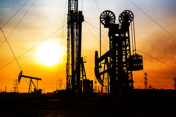 In the evening, the silhouette of oilfield derrick