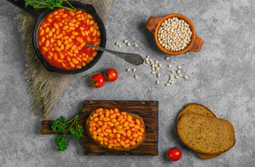 Braised beans in tomato sauce in cast iron pan