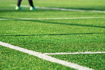 Artificial green grass with white stripe of soccer field - Powered by Adobe