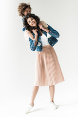 daughter sitting on shoulders of mother