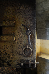 Rusty old heavy metal door in an underground bunker at Point du Hoc France