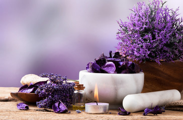 spa massage setting, lavender product, oil on wooden background