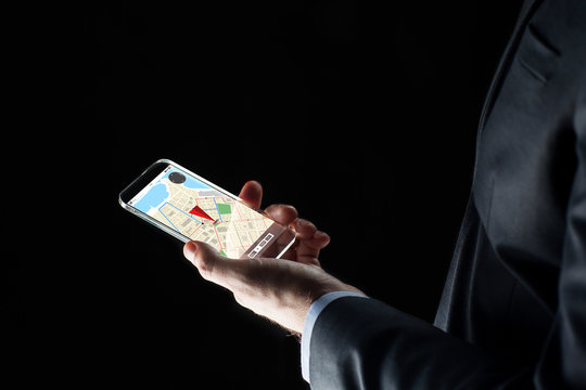 close up of businessman with gps map on smartphone