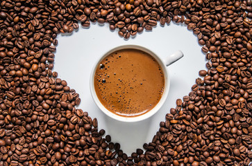 Coffee cup and coffee beans on table, top view