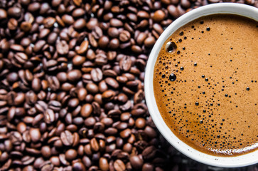 Coffee cup and coffee beans on table, top view, love coffee, Brown coffee beans isolated on white background, Hot Coffee cup with Coffee beans
