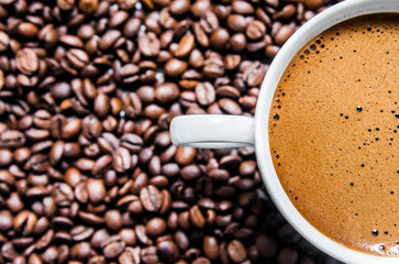 Coffee cup and coffee beans on table, top view, love coffee, Brown coffee beans isolated on white background, Hot Coffee cup with Coffee beans