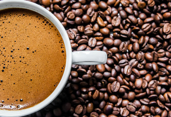 Coffee cup and coffee beans on table, top view, love coffee, Brown coffee beans isolated on white background, Hot Coffee cup with Coffee beans