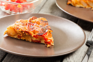 Tortilla de patatas. Spanish omelette with sausage chorizo, potatoes, paprika and egg, accompanied by olive oil
