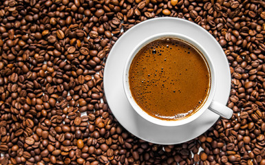 Coffee cup and coffee beans on table, top view, love coffee, Brown coffee beans isolated on white background, Hot Coffee cup with Coffee beans