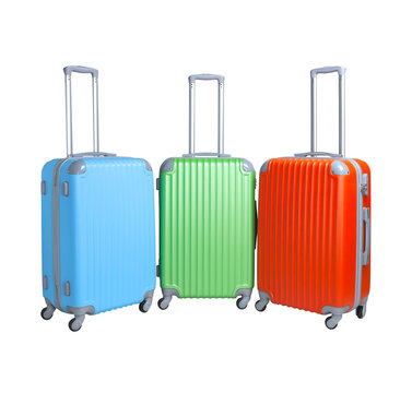 Three suitcases isolated on white background. Polycarbonate suitcases isolated on white. Blue, green and red suitcases.