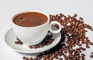 Coffee cup and beans on a white background.