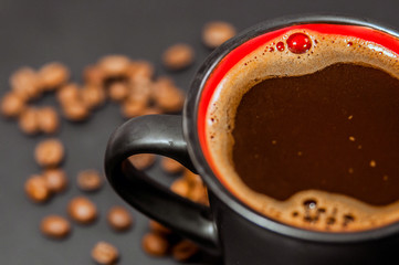 Style big black cup of coffee isolated on black background