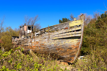 Remains of old fishing wooden boat on the shore of Baltic Sea in Hel Peninsula. Poland.