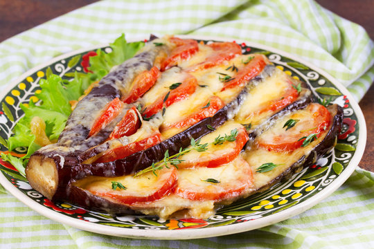 Eggplant with tomatoes, mozzarella, cheddar cheese and thyme