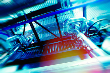 Industrial Factory. Various mechanisms and metal pipes. Toned image. Motion blur effect.