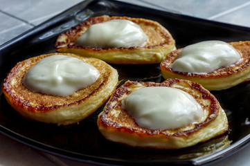 pancakes with natural yogurt on black plate
