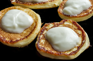 pancakes with natural yogurt on black plate