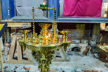 Wax candles on a floor candlestick in the Christian temple
