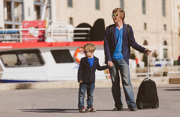 father and little son travel on quay in Europe