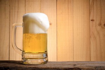 Beer glass on wood background.