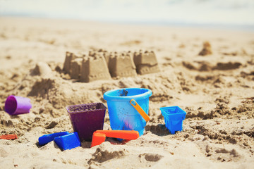 Fototapeta na wymiar kids toys and castles from sand on beach