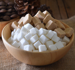 Sugar cubes white ,sugar cubes cane  in wood bowl on wooden