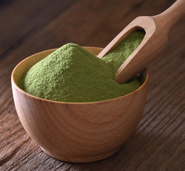 Green tea matcha on wooden background