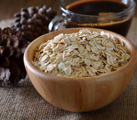 Rolled oats,Barley in bowl on wooden background