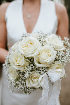 bride holding white boquet