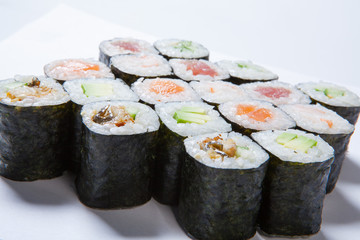 A plate with different kinds of sushi and rolls